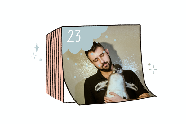 Illustration of tearaway calendar with the number 23. A photo inset of a bearded man looking at a baby penguin that he holds against his chest. 